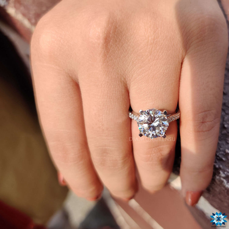 White gold ring with octagon moissanite and pave setting.

