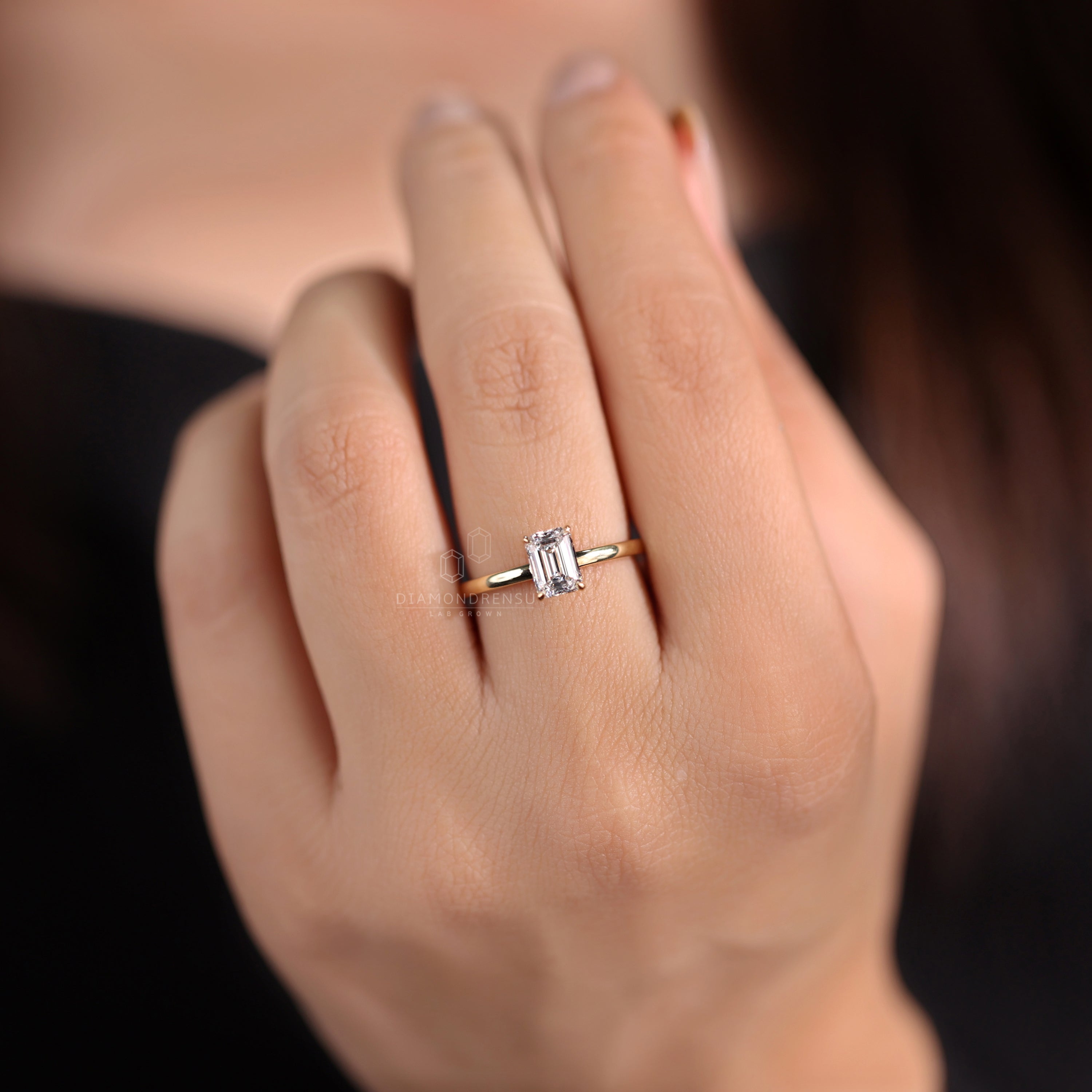 Emerald cut solitaire ring for timeless sophistication.