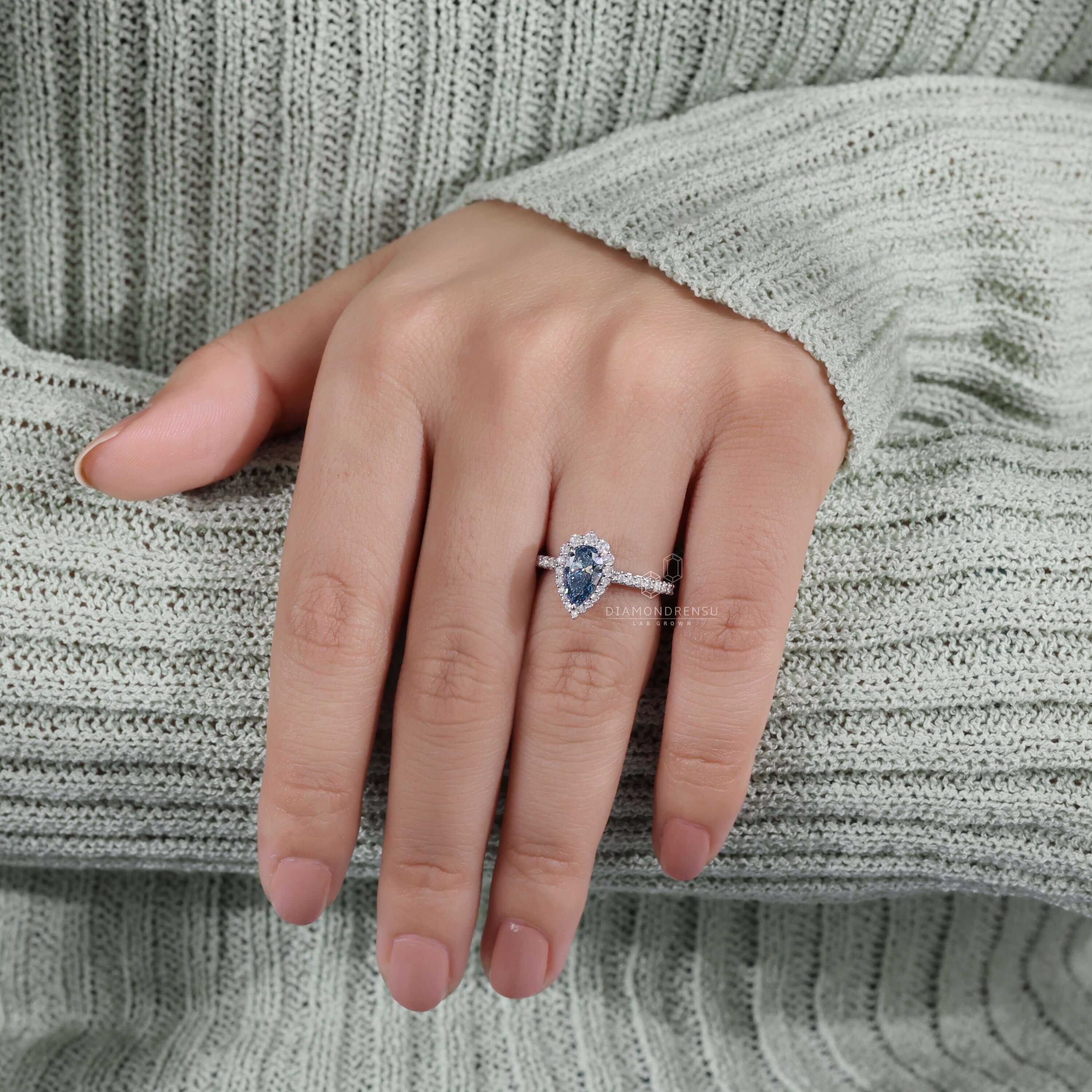 Pear engagement ring with halo showcasing lab grown diamonds.