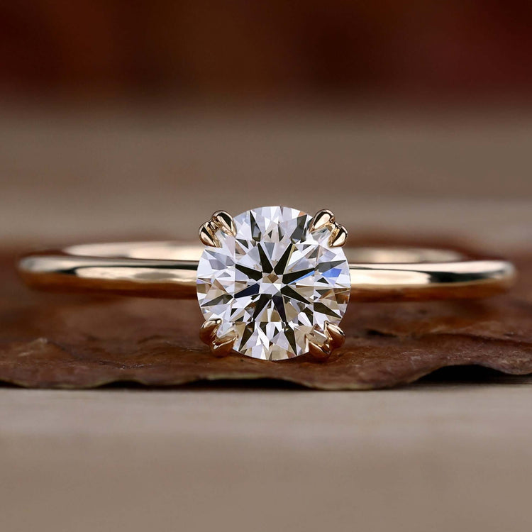 Solitaire diamond ring with a double claw prong setting for timeless elegance.