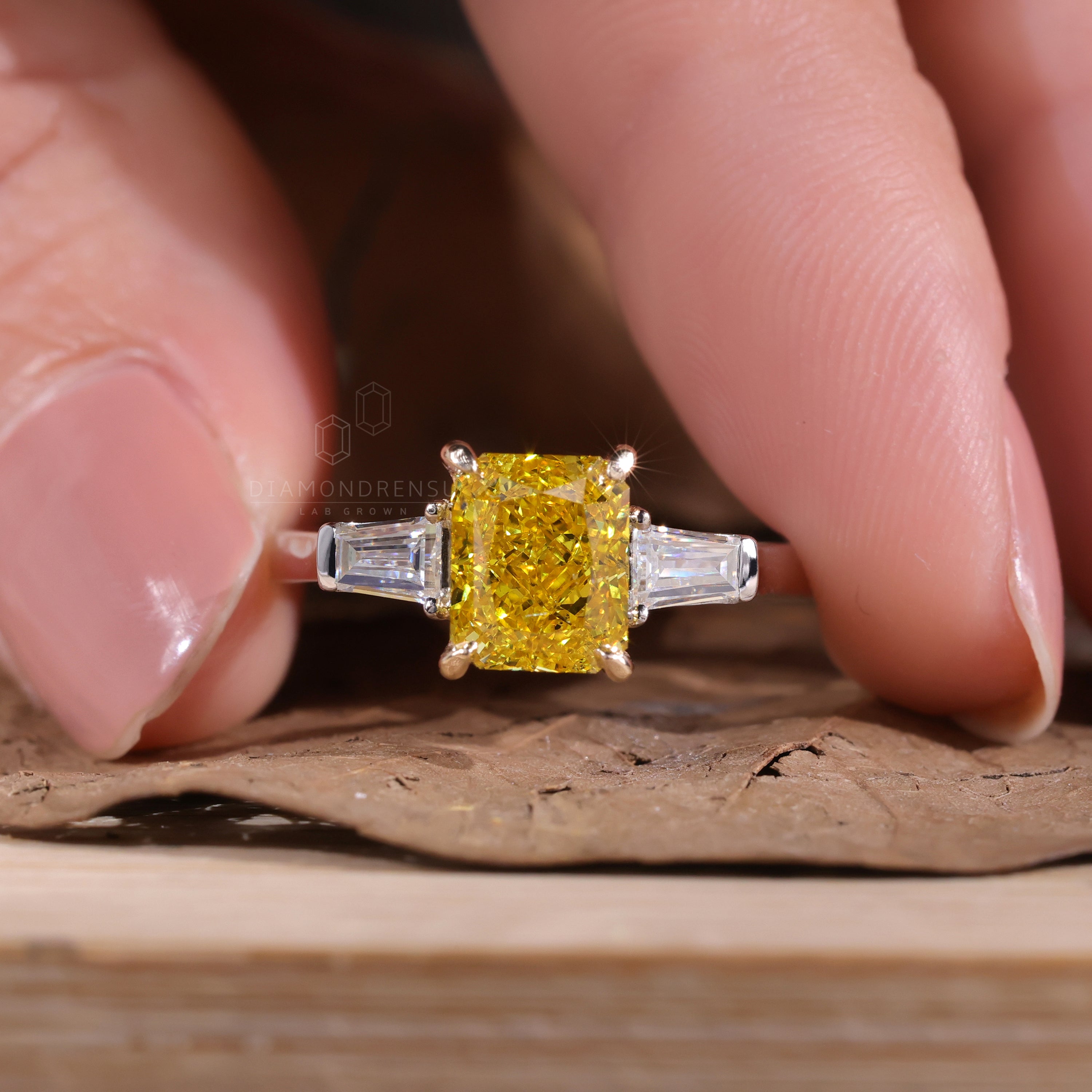 Fancy vivid yellow diamond ring in a 3 stone white gold engagement ring style.