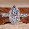 Marquise diamond ring with pave diamond accents in a unique engagement ring design.
