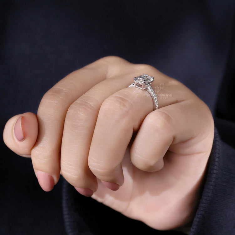 Claw prong setting emerald proposal ring featuring an elegant pave diamond ring with Round Cut Diamond Side Stones.