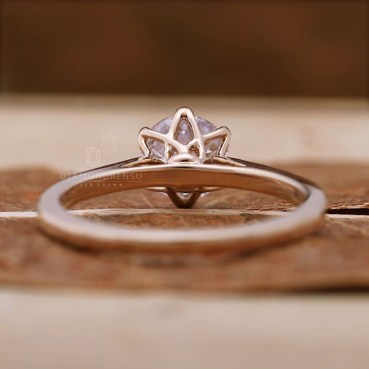 Handmade jewellery featuring a round diamond engagement ring with intricate details
