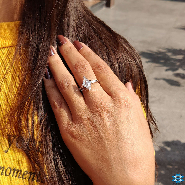 White gold ring with lozenge cut center stone.
