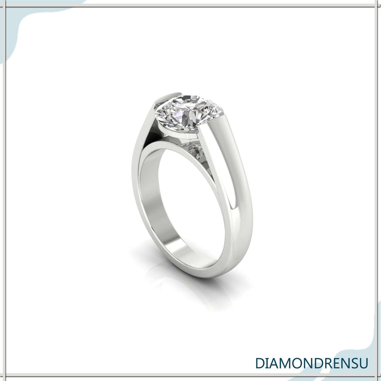 Wedding ring for men with round brilliant cut diamond in tension set.
