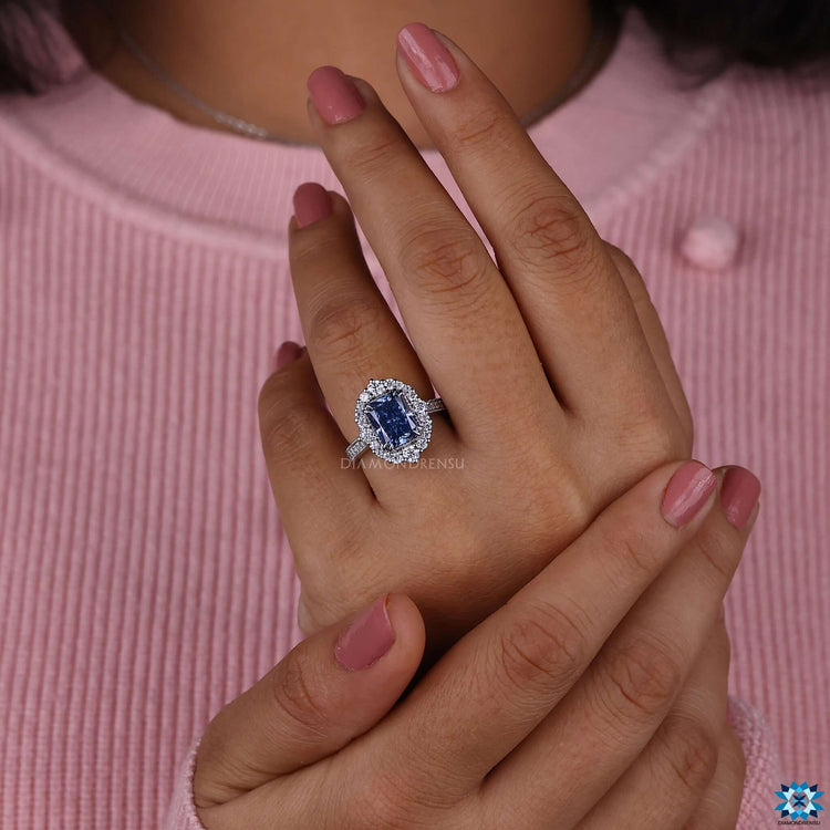 Radiant cut moissanite ring with halo and pave band design.
