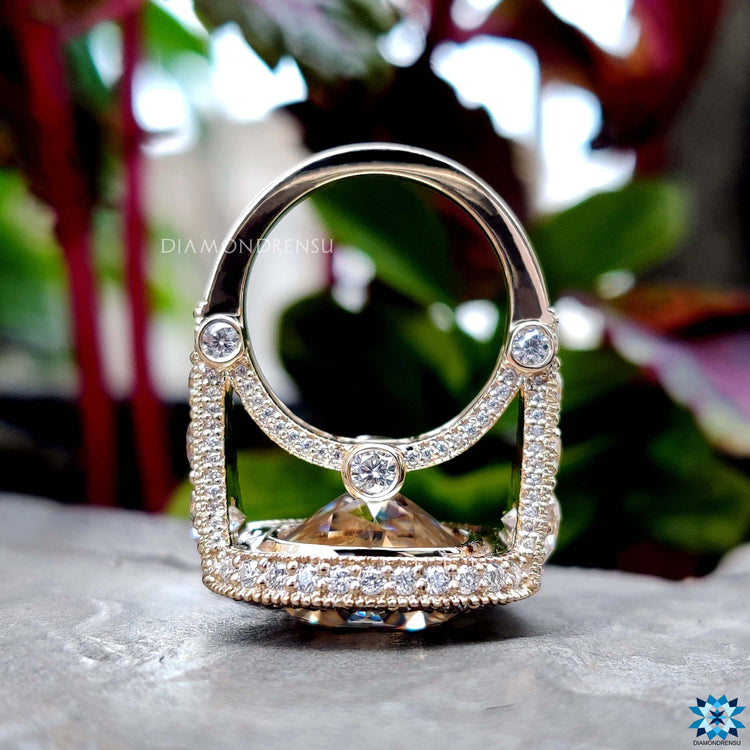 Milgrain setting moissanite ring with cushion cut design.
