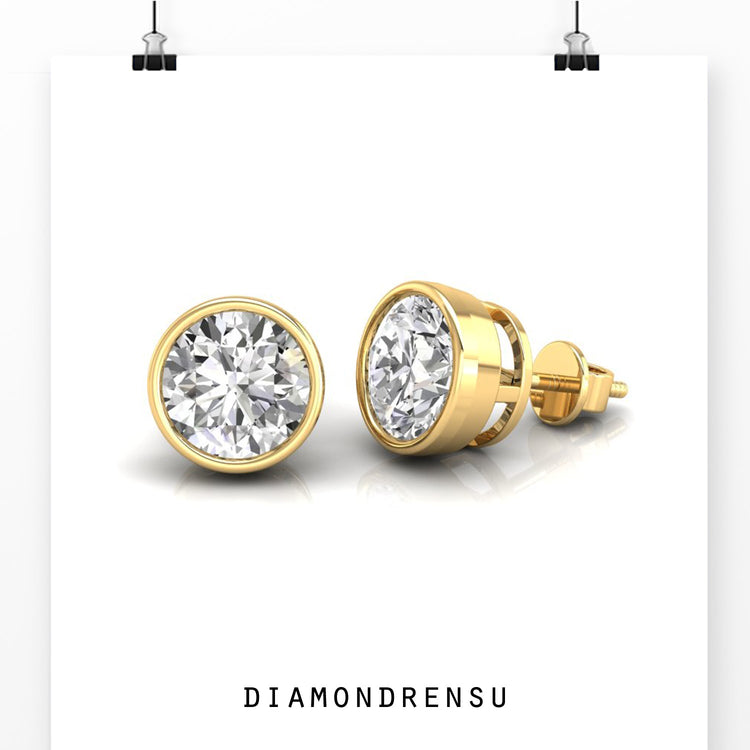 White gold diamond stud earrings with secure bezel mount.
