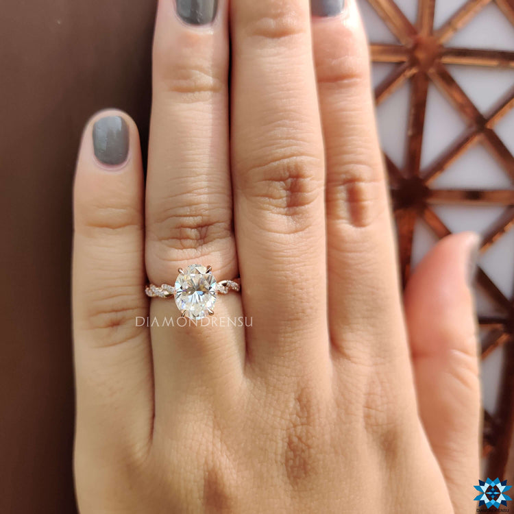 Handmade rose gold engagement ring with oval moissanite center.
