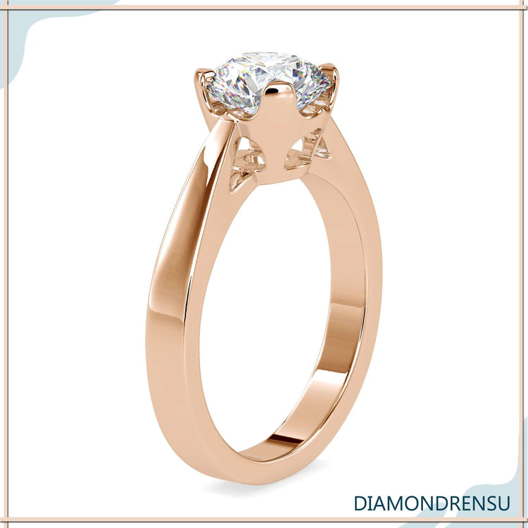 Designer ring in rose gold with basket setting and round diamond.
