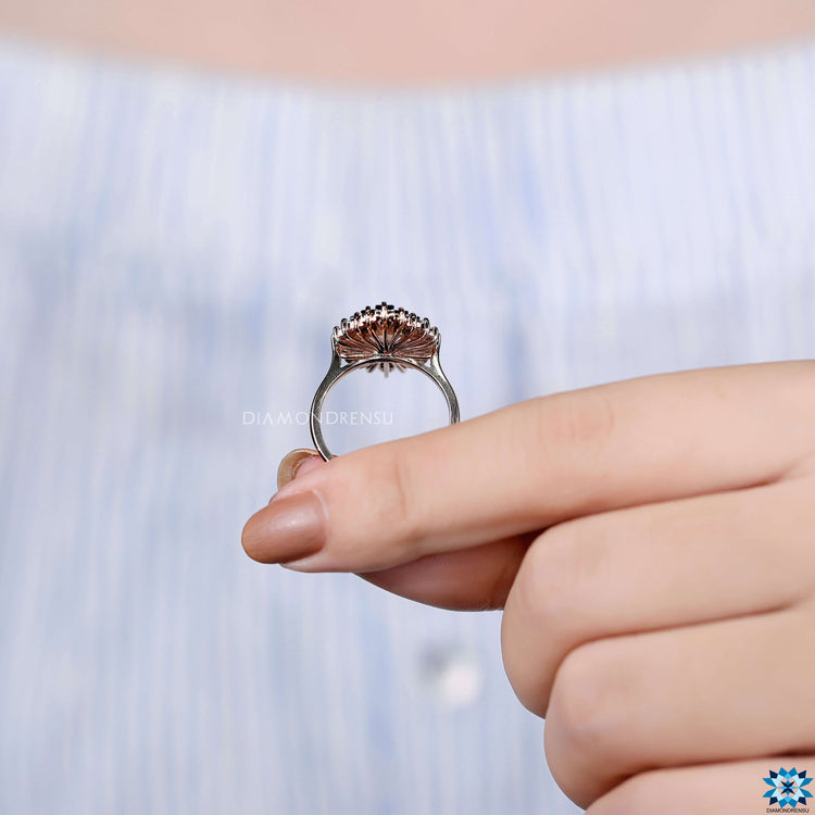 Pink round moissanite stones in double halo ring.
