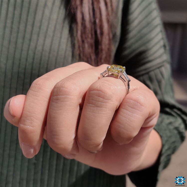 Moissanite three stone ring with baguette accents.
