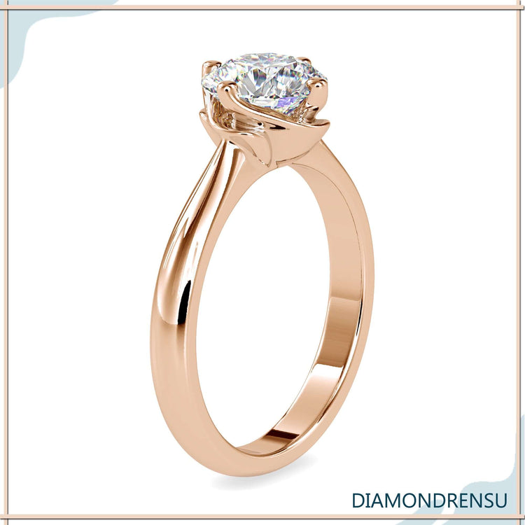Yellow gold ring with four prong round diamond setting.
