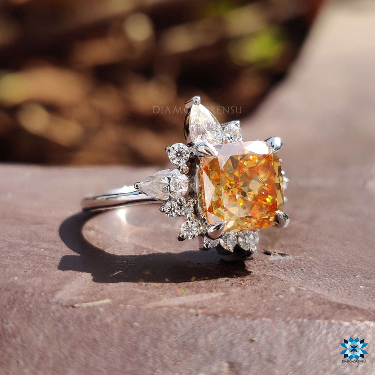 White gold engagement ring with cushion champagne moissanite and side accents.
