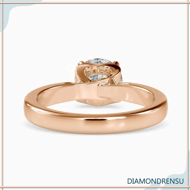 Yellow gold ring with 4 prong setting and hidden heart design.
