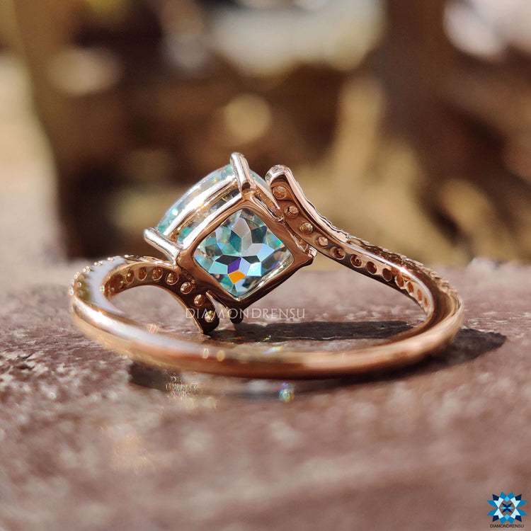 Cyan blue moissanite ring with unique bypass and prong detailing.
