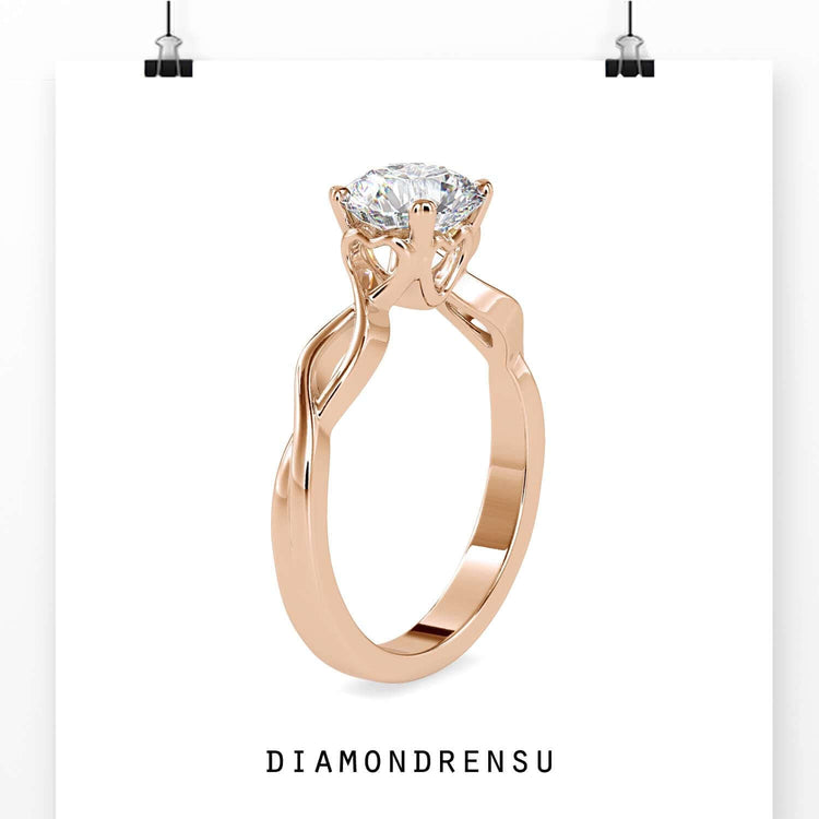Rose gold engagement ring with twisted band design.

