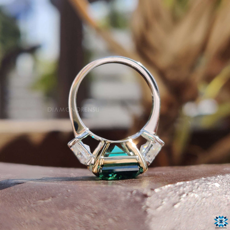 Three stone moissanite ring in a two tone setting.
