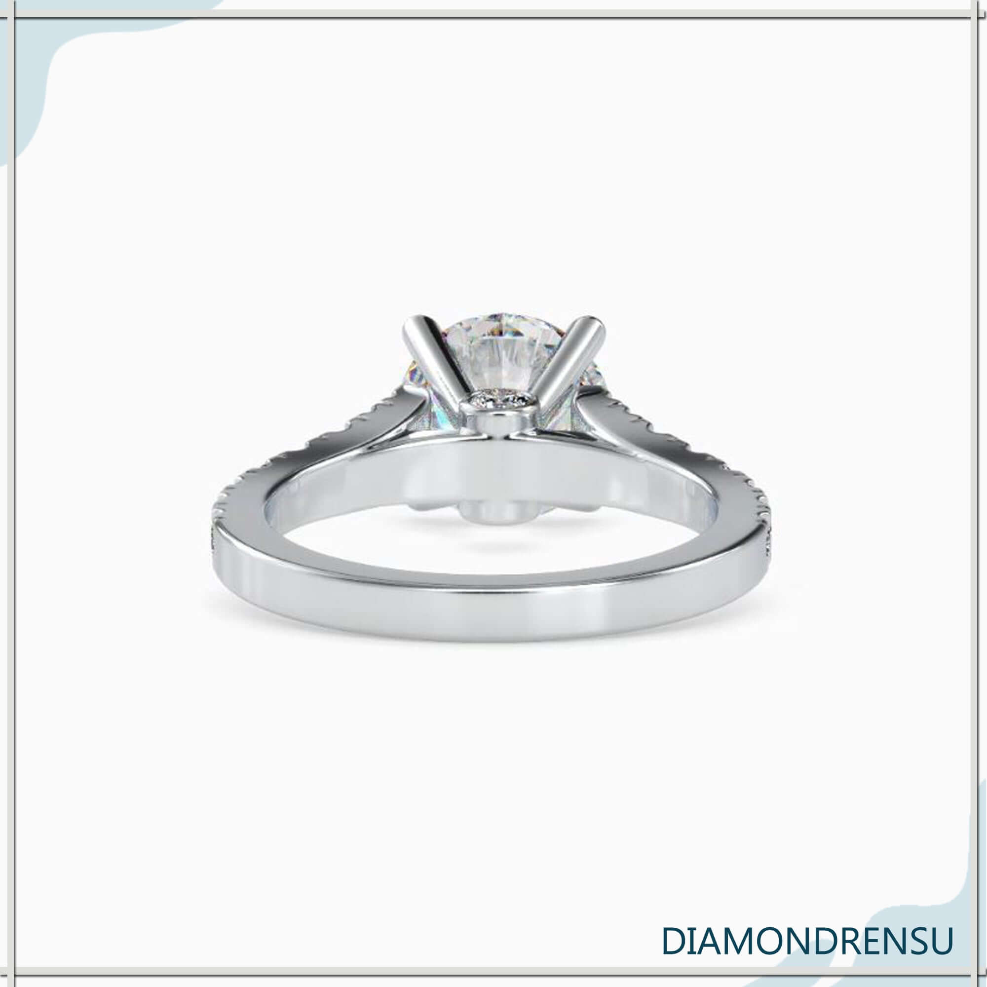 Round cut diamond engagement ring featuring a peek a boo diamond
