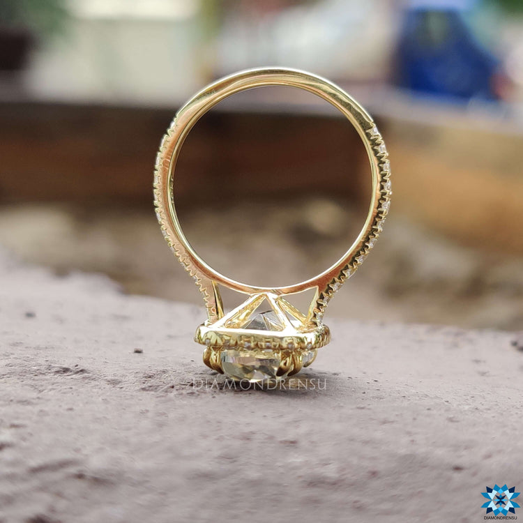 Round pave band ring with halo cushion moissanite center.
