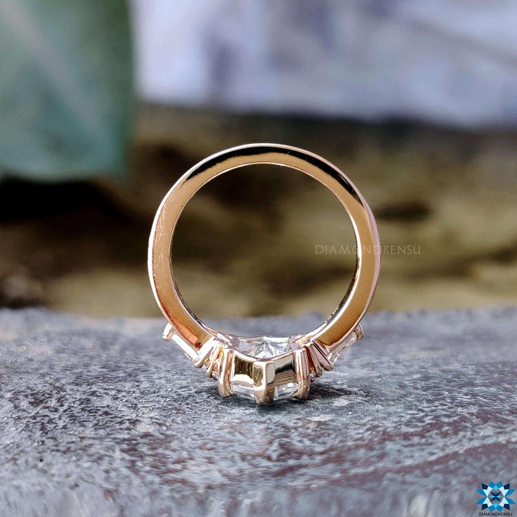 Round cut moissanite ring with pave engagement design.
