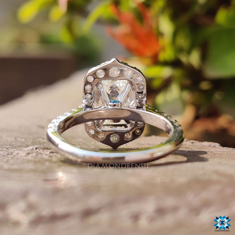 Halo engagement ring with double prong criss cut center.
