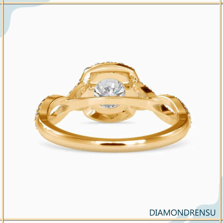 Yellow gold ring featuring twist band and round diamond.
