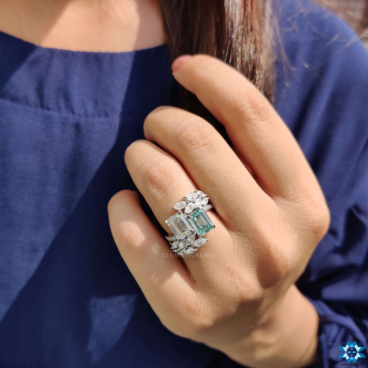White gold ring with marquise and round cut side stones.
