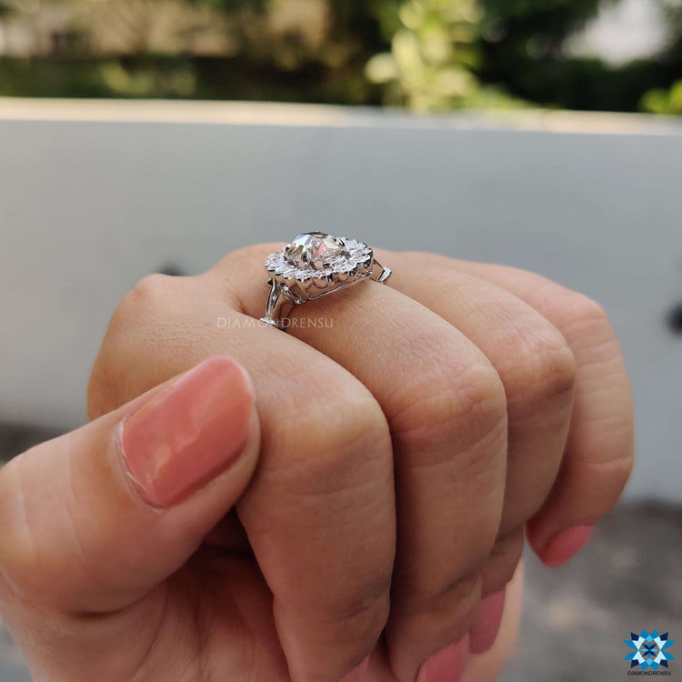 Prong setting ring crafted with an oval rose cut centre and round halo.
