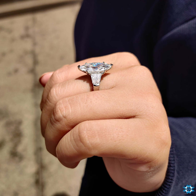 3 stone moissanite ring with bullet cut accents and handcrafted setting.
