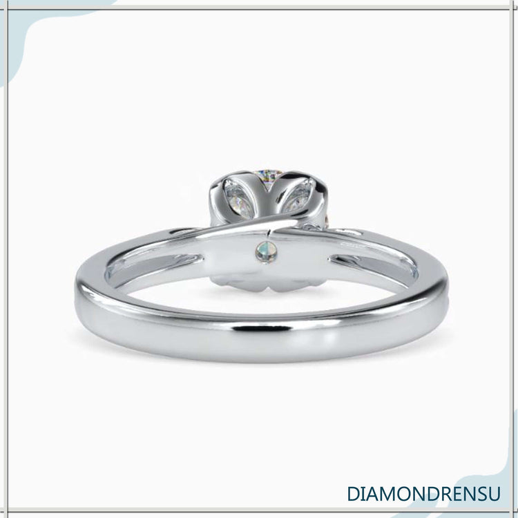 Petal prong ring crafted with round cut diamond in cathedral design.
