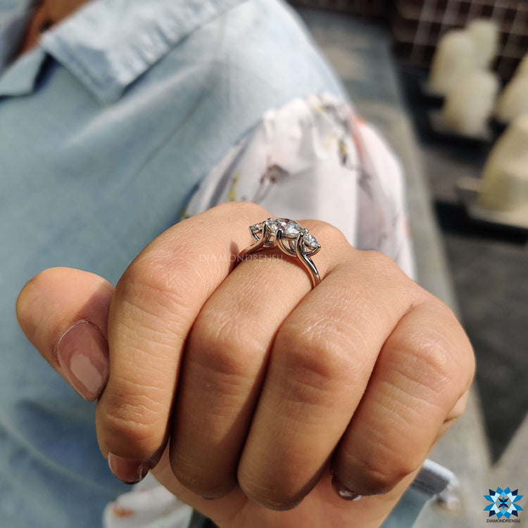 Elegant three stone moissanite ring in round cut.
