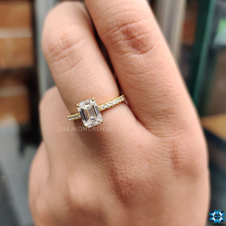 Elegant yellow gold engagement ring with moissanite center.
