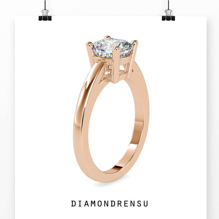 White gold engagement ring with a cushion cut diamond in a classic 4 prong setting.
