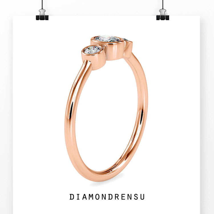 Yellow gold engagement ring featuring oval diamond and bezel set sides.
