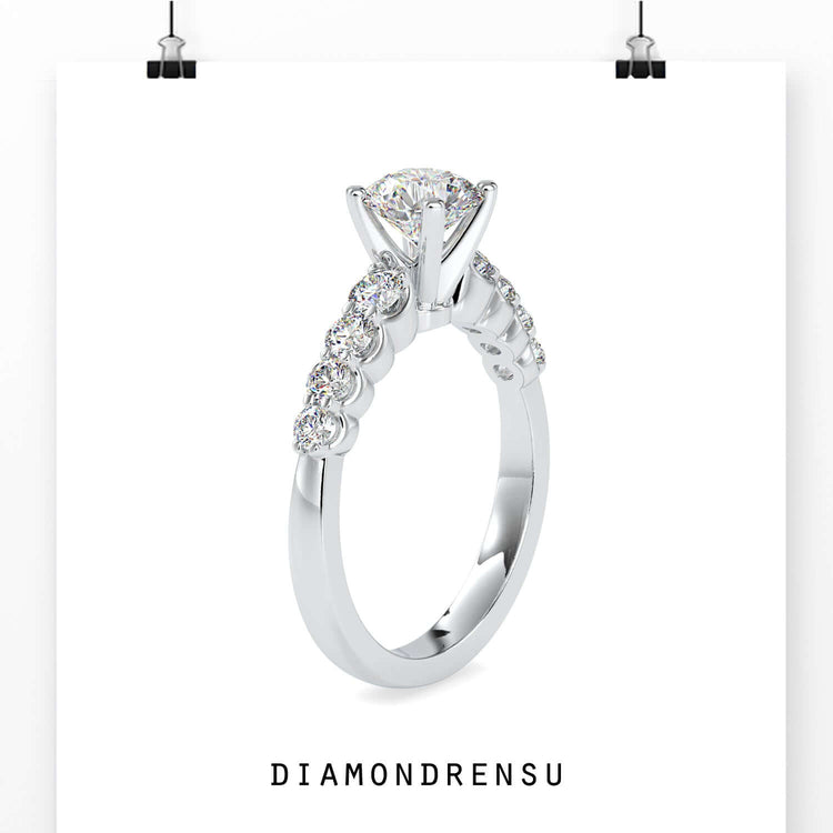 UK engagement ring with round cut lab grown diamond and tab prong setting.
