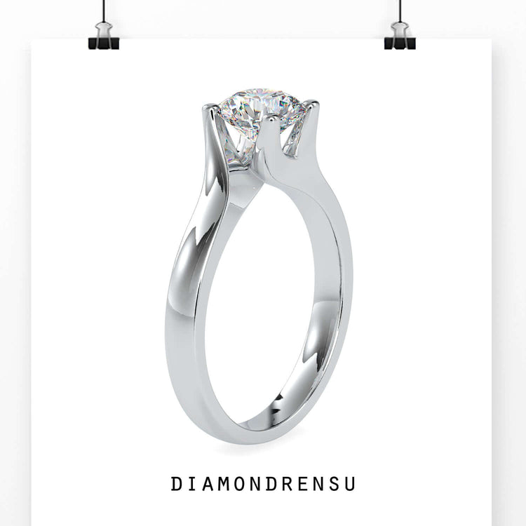 Solitaire engagement ring in rose gold with bypass style.
