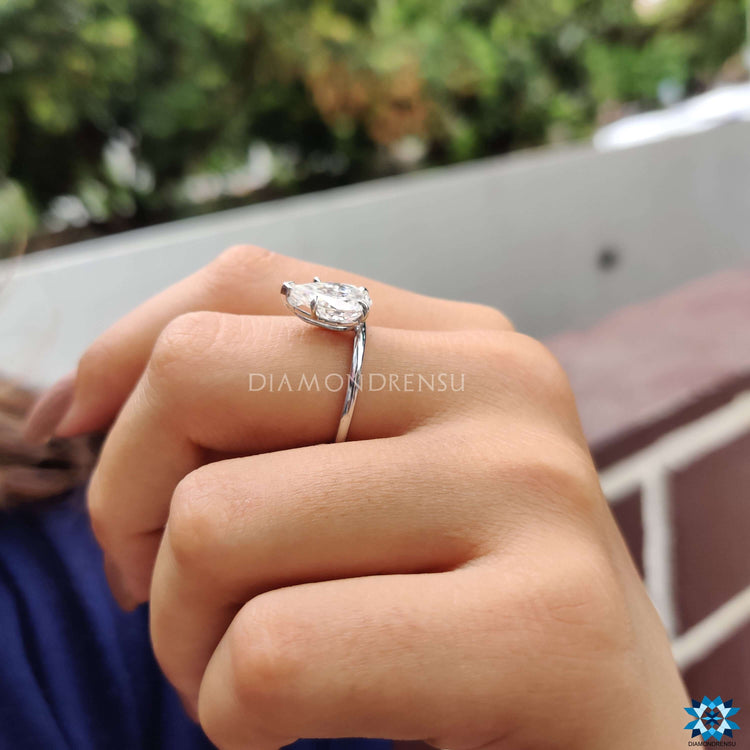 Handmade jewellery piece with v shaped prong and pear Rensu moissanite in white gold.
