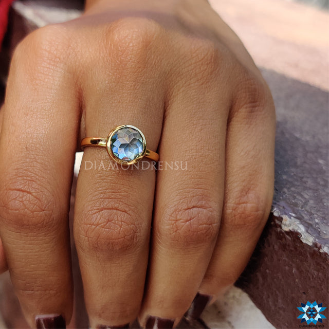 Yellow gold bezel ring with round rose cut moissanite centre.
