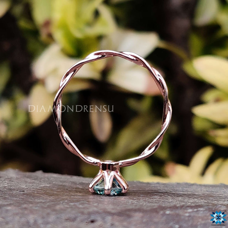 Handmade ring featuring a round moissanite center stone.

