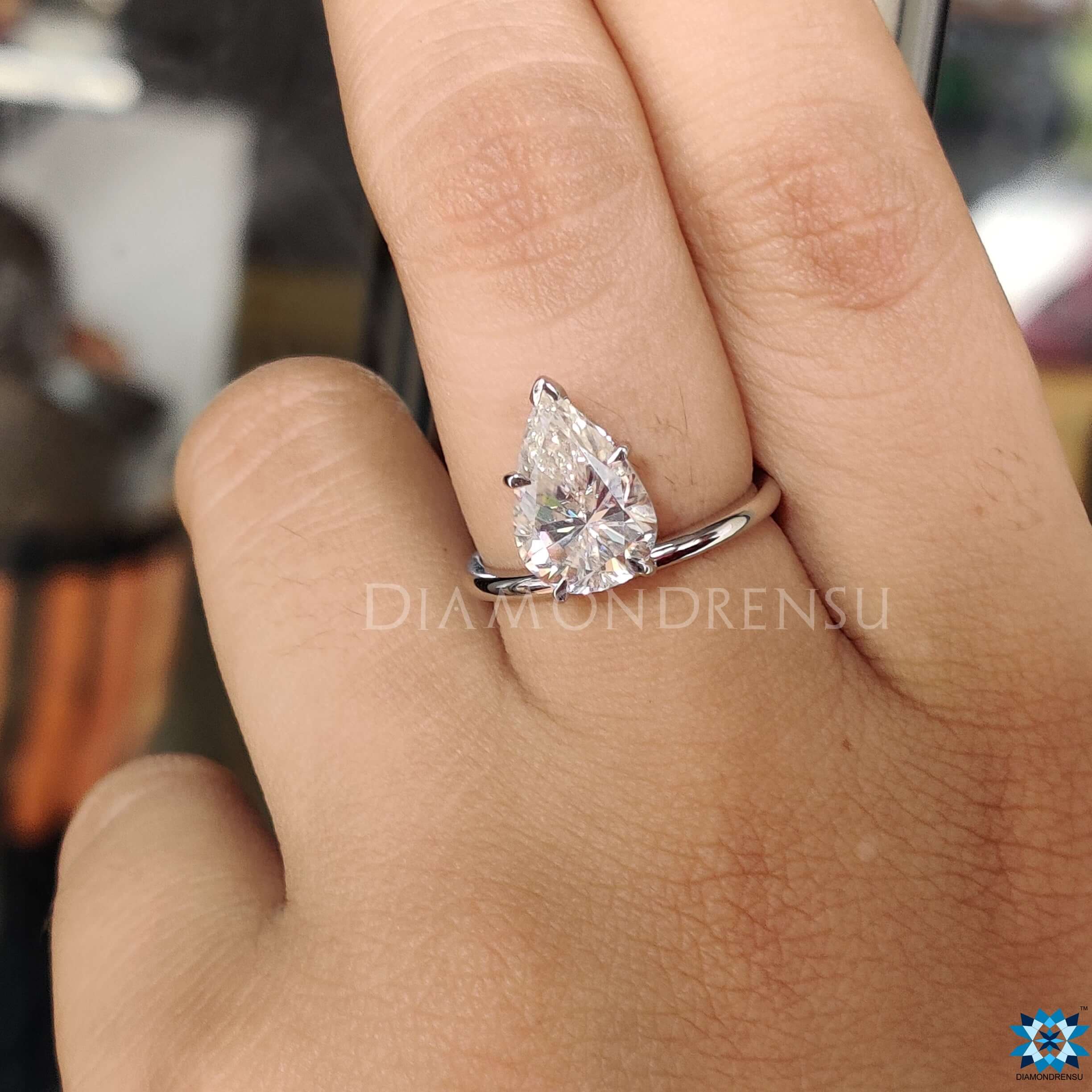 Upside down engagement ring with a stunning pear moissanite engagement ring.