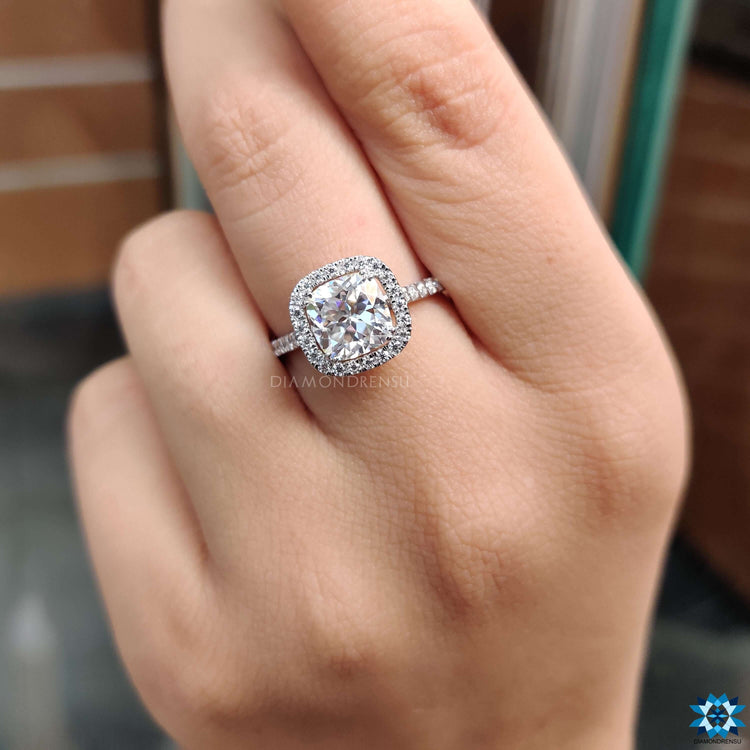 Buy moissanite ring in white gold with pave and halo detailing.

