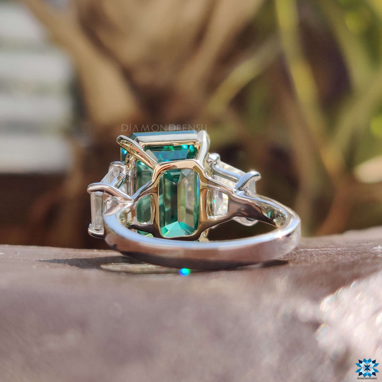 Custom engagement ring with green emerald moissanite.
