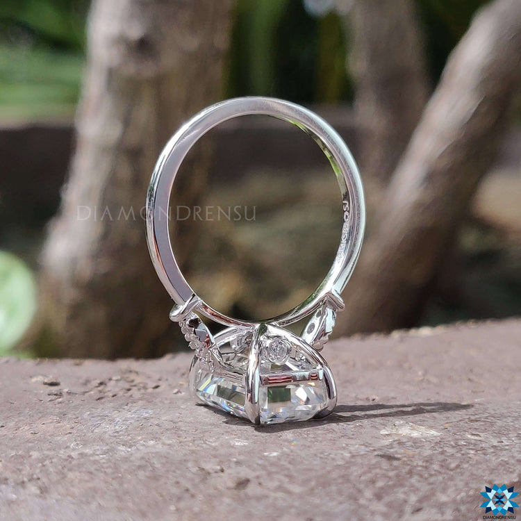 Custom white gold engagement ring with emerald cut moissanite.
