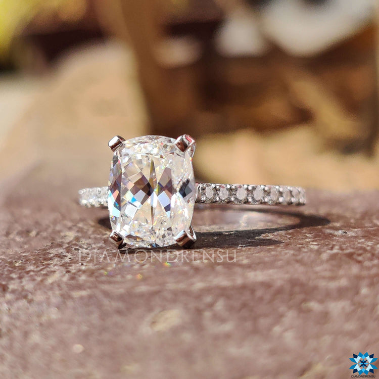 Moissanite engagement ring in white gold with round pave band.
