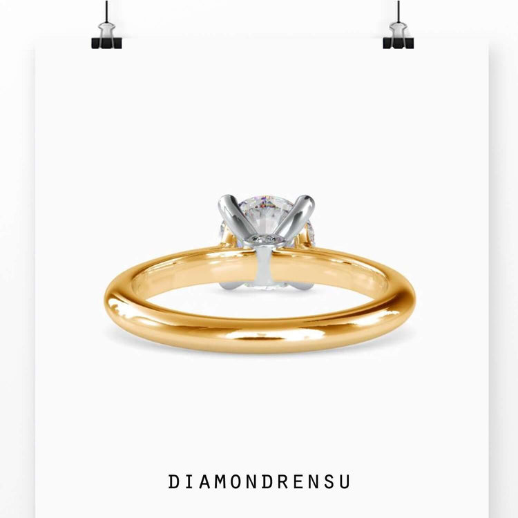 Custom design ring with round solitaire and tapered detail.
