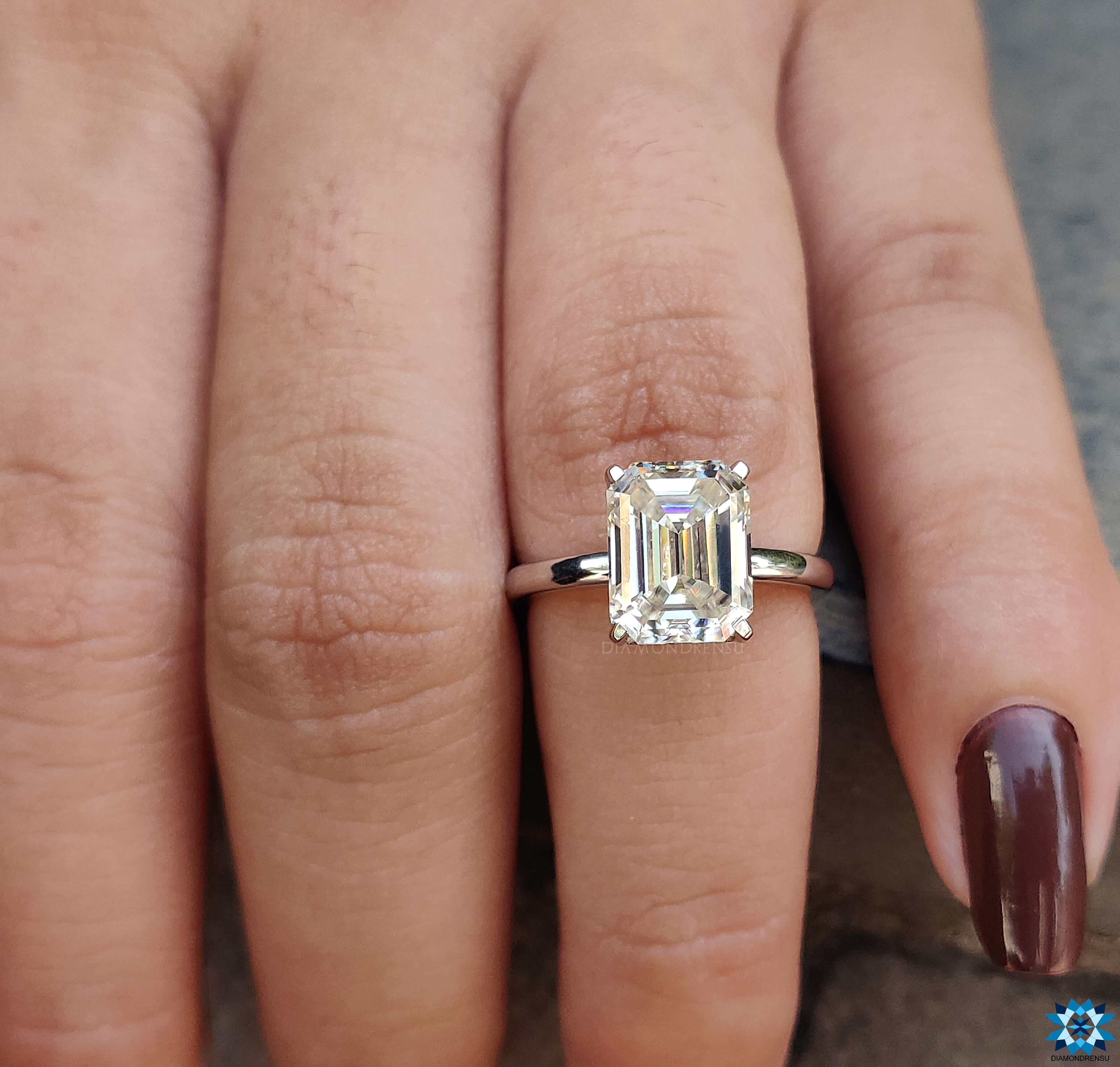 Custom ring with an Emerald Cut Moissanite Ring and intricate prong setting.