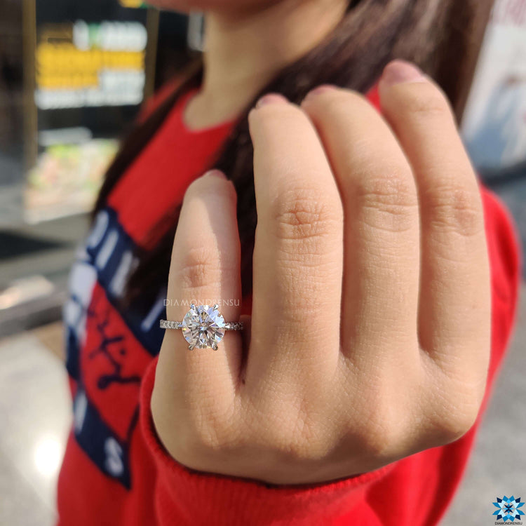 White gold engagement ring with pave band.

