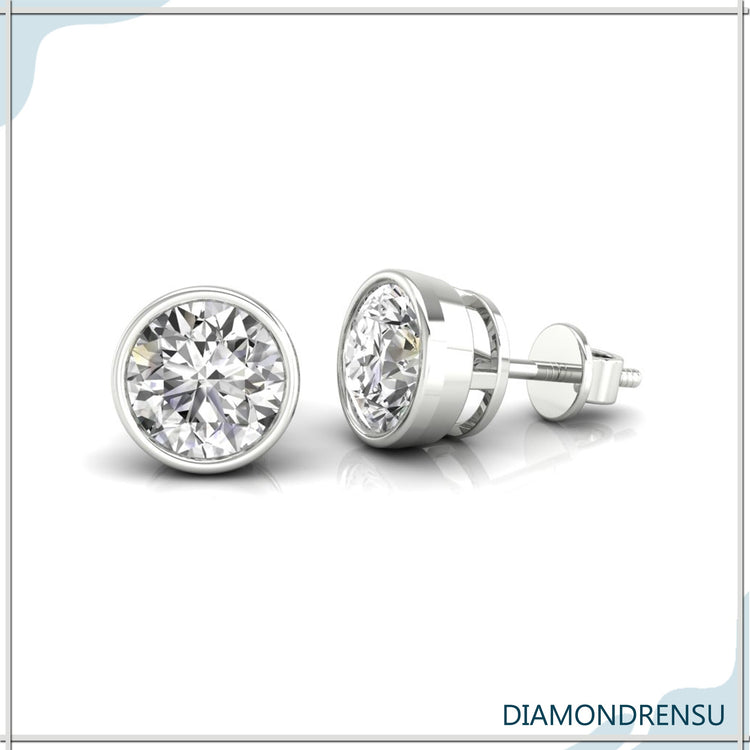 White gold bezel diamond stud earrings with smooth edges and round diamonds.
